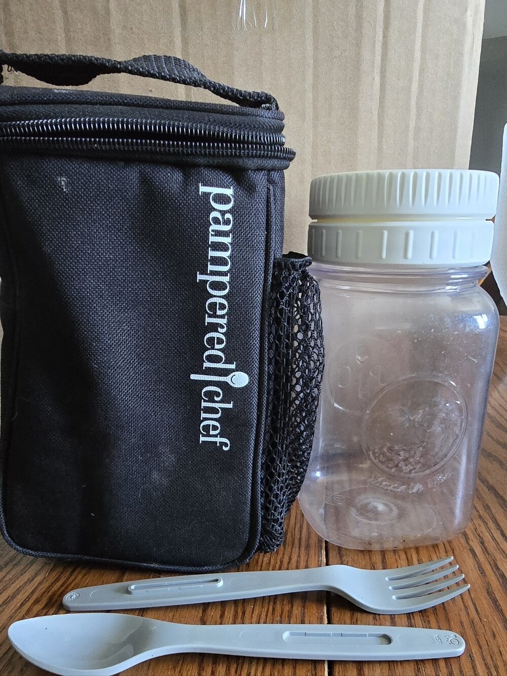 Pampered Chef Black Lunch Tote with White Jar Lid and Gray Utensils